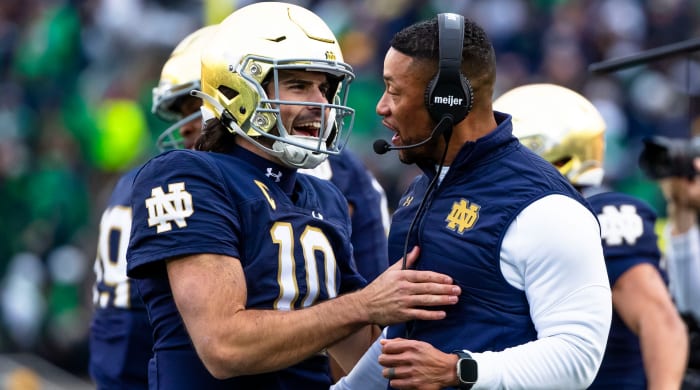 Notre Dame quarterback Sam Hartman celebrates with head coach Marcus Freeman during the Fighting Irish’s win over Pitt.